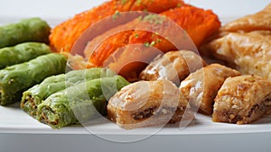 A tray of Turkish pastries including baklava, knafeh -  a Middle Eastern cheese pastry soaked in sweet, sugar-based syrup