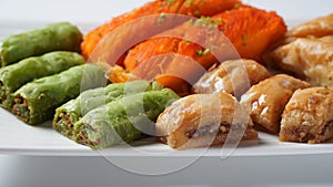 A tray of Turkish pastries including baklava, knafeh -  a Middle Eastern cheese pastry soaked in sweet, sugar-based syrup