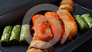 A tray of Turkish pastries including baklava, knafeh -  a Middle Eastern cheese pastry soaked in sweet, sugar-based syrup