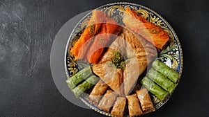 A tray of Turkish pastries including baklava, knafeh -  a Middle Eastern cheese pastry soaked in sweet, sugar-based syrup