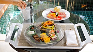 Tray with various sweet dessert cakes, patisseries, croissant, fruits photo