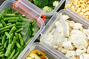 Trays with raw vegetables for freezing.