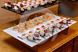 Trays with various delicious appetizer. Catering banquet table