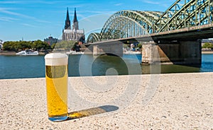 A TraÂ­diÂ­tioÂ­nal beer KÃ¶lsch at Cologne with cathedral and hohenzollern bridge