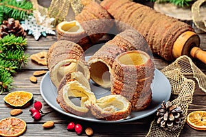 Trdelnik is a baked delicacy on a spit and charcoal dough with sugar, cinnamon and vanilla. Christmas sweets, street food. Czech
