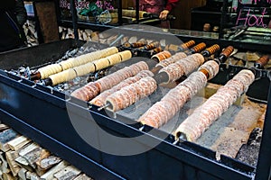 Trdelnik, traditional dessert baked in an open fire wooden stake in Prague Christmas Market.