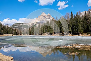 Tre Cime di Lavaredo and its reflection over Lake Antorno in winter