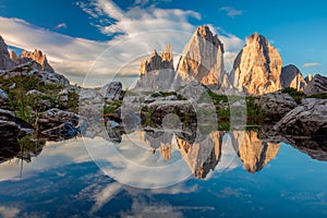 Tre Cime di Lavaredo with real reflection in lake, Dolomites Alps Mountains photo