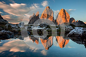 Tre Cime di Lavaredo with reflection in lake at sundown, Dolomites Alps