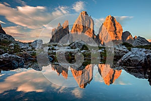 Tre Cime di Lavaredo with reflection in lake at sundown, Dolomites Alps