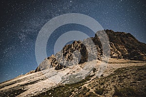 Tre Cime Dolomiti and night sky with galaxy