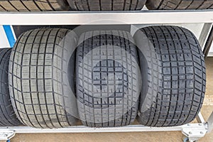 Tread pattern on large rubber speedway tyres in the pit area before a race