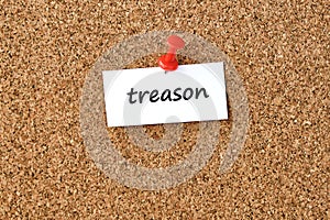 Treason. Word written on a piece of paper, cork board background