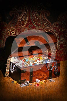 Treasure chest filled wiht precious stones and jewelry