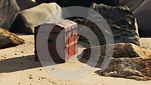 Treasure chest in sand dunes on a beach