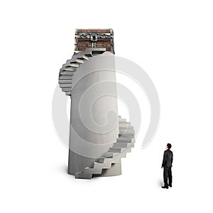 Treasure chest on spiral staircase with man looking up