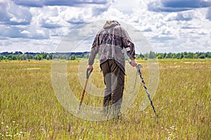 Treasure hunter in the field with a metal detector