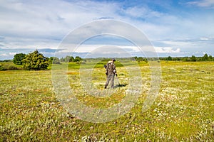 Treasure hunter in the field with a metal detector