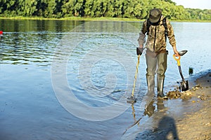 Treasure hunter is looking for a metal detector in the river