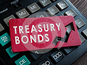 Treasury bonds on the red plate and calculator.