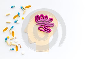 Treat brain diseases. Head with plastiline meanders and pills on white background top view copy space