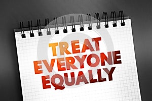 Treat Everyone Equally text quote on notepad, concept background