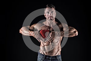 Treat your heart with love. Strong man hold red heart. Giving heart for valentines day. Cardiovascular health. Healthy