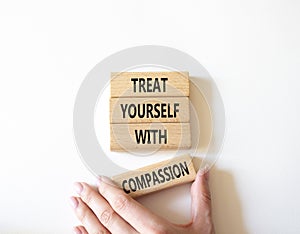 Treat yourself with compassion symbol. Concept words Treat yourself with compassion on wooden blocks. Beautiful white background.