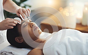 Treat yourself to some TLC. Shot of an attractive young woman getting a massage at a spa.