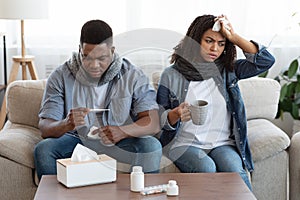 Treating Coronavirus At Home. Sick Black Couple Suffering From Covid-19 Symptoms photo