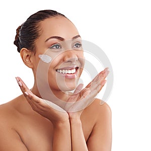 Treating her skin with the care it deserves. Studio shot of a beautiful young woman with moisturizer on her skin.