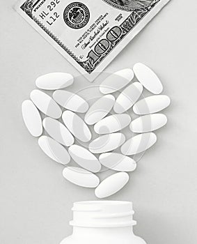 Treatment covid, Heart made of pills and money over the neck of a bottle. Paid medical service, bribe in pharmaceutical company