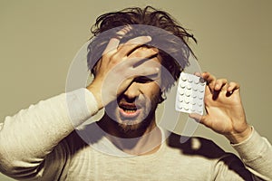 Treatment of depressions. Guy hold dieting pill and vitamin