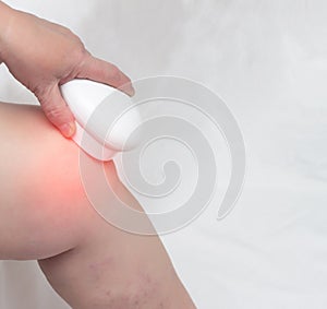 Treatment of the knee by magnetic therapy, physiotherapy of the knee, close-up, copy space