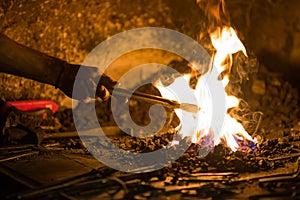 Treatment of molten metal close-up. Handmade blacksmith