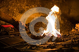 Treatment of molten metal close-up. Handmade blacksmith