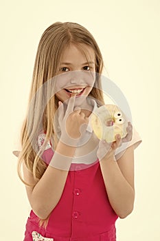 Treats for holidays. Kid rewarded for good behavior with sugary treats. Girl cute smiling face holds sweet donut. Girl photo