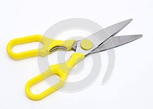 A large pair of scissors with yellow handles photo