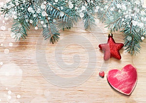 Tree branches with stars, heart and snow on wooden board