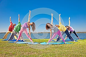 Tree couple , man and woman practice Yoga asana on lakeside.