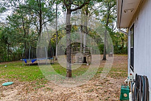 A tree house and a trampoline on a compound in Texas USA