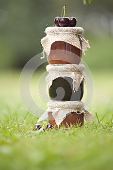 Tree jars of jam with cherries