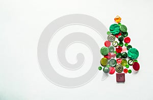 Tree made of buttons of green, red color. white background, copy space. Creative Christmas Concept or gardening