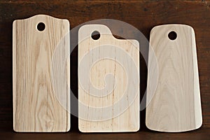 Tree new cutting boards with beautiful texture of ash, elm and red alder on antique wood background