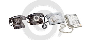 Tree old telephone sets and modern landline telephone