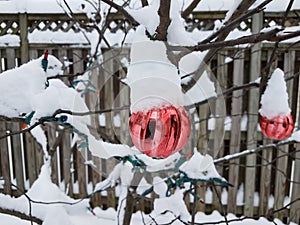 Tree with red Christmas ornaments and snow