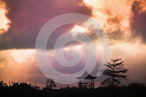 Tree and religious gazebo against the sky