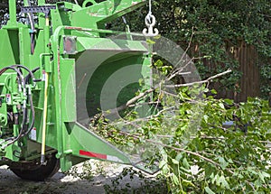 Industrial chipper mulching branches photo
