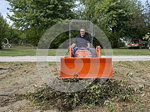 Tree Trimmer Stomping Down Tree Limb Pile