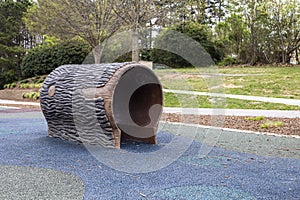 A tree trunk tunnel for children to play at Salem Pond Park